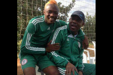 Ahmed Musa (left) in his new look, shares a joke with Super Eagles Coach, Stephen Keshi at their Faro camp in Portugal.