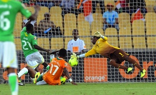 Ivory Coast keeper, Boubacar Barry parries  a shot by Togo defender, Dakonam Djene