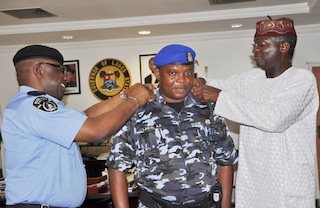 CSO Lawal being decorated with new rank of CSP