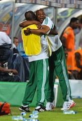 Coach stephen keshi, right, hugs a member of the technical crew