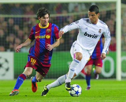 DRIBBLE: Real Madrid's Cristiano Ronaldo (right) dribbles Lionel Messi of Barcelona during a match played recently. The duo clash again in the El-Classico