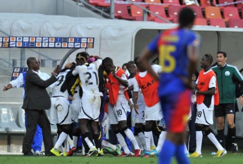 Ghana coach Kwesi Appiah, left, celebrates with his players after they qualified for semi finals AFP