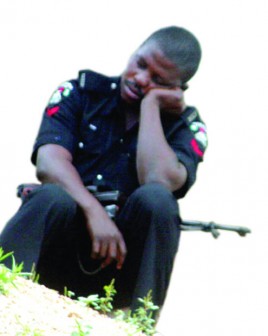 A sad Nigerian police officer