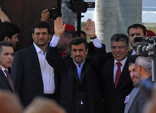 Iranian President Mahmoud Ahmadinejad  waving at the funeral. AFP