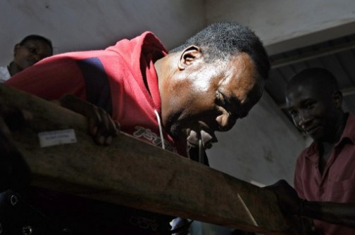 Conrad Njeru Karukenya: removing nails from wood with his teeth. AFP