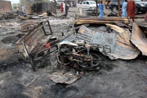 A burnt motorcyle lies in a street of the remote northeast town of Baga on April 21, 2013 .AFP