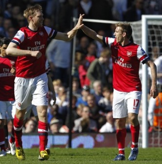 Arsenal's German defender Per Mertesacker (L) celebrates scoring the opening goal with Arsenal's Spanish defender Nacho Monreal. AFP