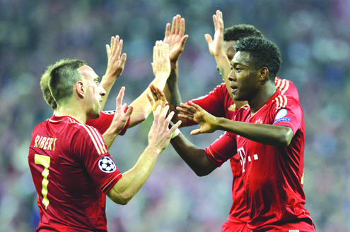 CELEBRATION: Bayern Munichs French midfielder Franck Ribery (left) and Bayern Munichs Austrian midfielder David Alaba (right) celebrate their victory over FC Barcelona during the UEFA champions league semi final first leg match in Munich, southern Germany yesterday. Bayern won 4-0.
