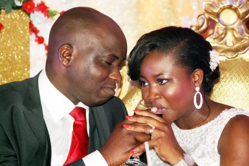 Bode Owolabi, giving his wife some wine to sip
