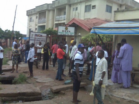 Electricity consumers in front of PHCN office at Customs bus stop. Abaranje, Ikotun, after it was attacked over crazy bills.