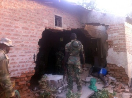 Bama prison: a soldier stands at the collapsed wall of Bama Prison after BH attack