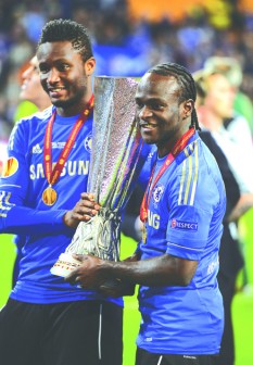 Mikel (left) and Moses celebrate with the Europa League trophy which Chelsea won last night. PHOTO: AFP