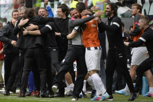 Juventus' coach Antonio Conte (C-L) celebrates after his team defeated Palermo to win the Scudetto, the Italian Serie A title on May 5,