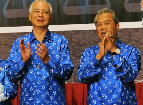 Malaysian Prime Minister Najib Razak (C), and his deputy Prime Minister Muhyiddin Yassin (R) applaud after their Barisan Nasional (National Front) coalition electoral victory, on May 6, 2013 at the Putra World Trade Centre in Kuala Lumpur.