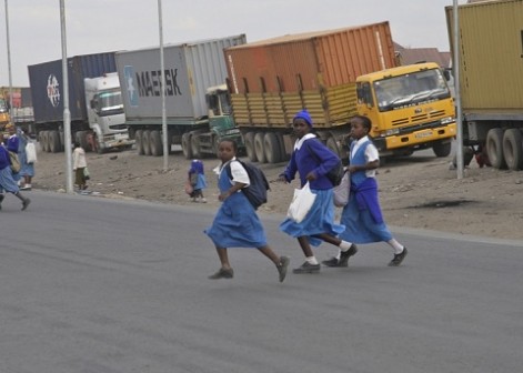 school children walk across a road : they need better protection