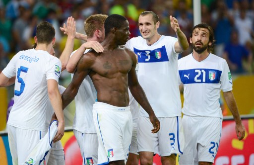 Balotelli celebrates with team mates but got booked