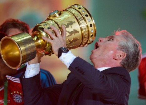 Bayern Munich's head coach Jupp Heynckes celebrates with the trophy after they won the final football match of the German Cup . AFP