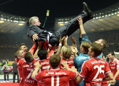 Bayern Munich's head coach Jupp Heynckes (up) is thrown in the air by his players after they won the final football match of the German Cup