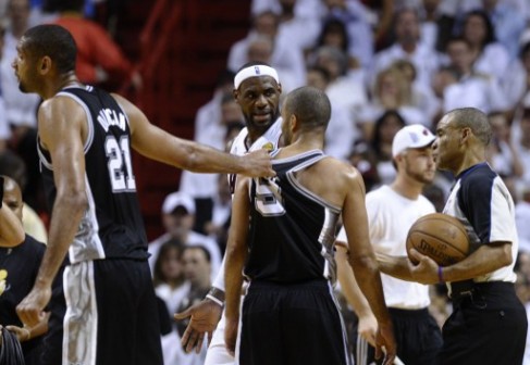 Tim Duncan (L) of the San Antonio Spurs pulls teammate Tony Parker away from arguing with the referee as LeBron James of the Miami Heat looks on during the third quarter of Game 7 of the NBA Finals at the American Airlines Arena June 20, 2013 in Miami, Florida. 