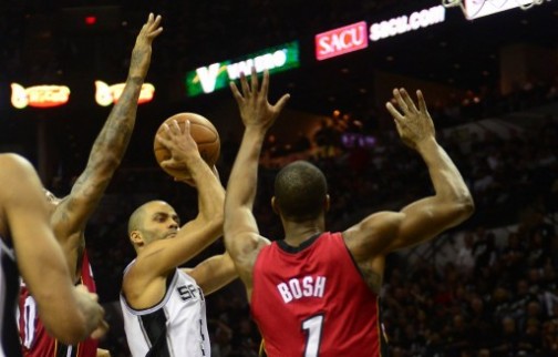 Tony Parker (C) of the San Antonio Spurs shoots under pressure from Chris Bosh (R) of the Miami Heat during game 3 of the NBA finals on June 11, 2013 in San Antonio, Texas. AFP