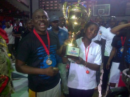 Owner of First Deepwater, Babatunde Babalola, right, holding the league trophy with one of the fans of the team after the final match yesterday