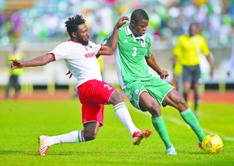 CLEARANCE: Nigerias Uwa Echiejile (right) vies for the ball with Kenyas David Ochieng  during the 2014 World Cup Qualifying match at the Kasarani Football Stadium in Nairobi yesterday. Nigeria won 1-0.  AFP PHOTO.