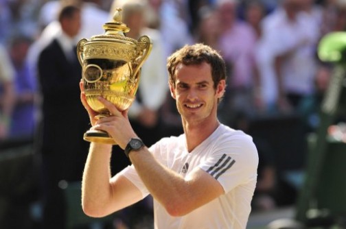 Britain's Andy Murray raises the winner's trophy after beating Serbia's Novak Djokovic in the men's singles final on day thirteen of the 2013 Wimbledon Championships tennis tournament at the All England Club in Wimbledon. AFP Photo