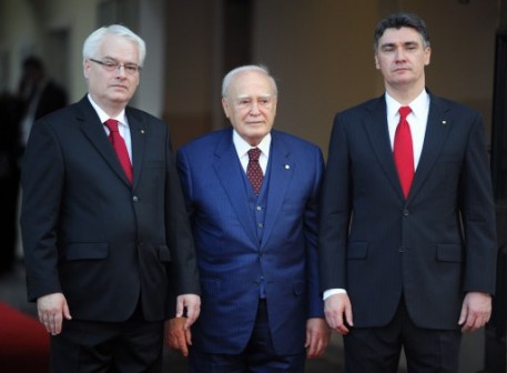 Croatia's President Ivo Josipovic (L) and Croatia's Prime Minister Zoran Milanovic (R) welcome Greek President Karolos Papoulias (C) at the celebration
