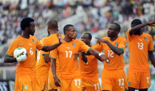 Ivorian player holds the ball to stop the free kick against them during the 2014 African Nations Championship (CHAN) qualification football match against Nigeria on July 6, 2013 in Kaduna.