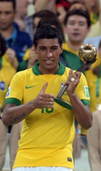 Brazil's midfielder Paulinho receives the trophy of the bronze ball after Brazil's victory over Spain 3-0 in the final game of the FIFA Confederations Cup 