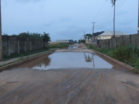 Road 15, second entrance to Lekki 2- there are multiple lakes here, deep, dangerous to vehicles. Note the interlocking blocks left by NTDA after it abandoned repairs of the road early this year