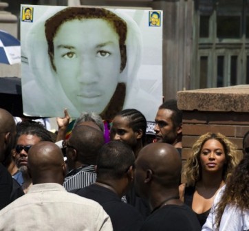 Singer Beyonce (R) listens to speakers at a rally for Trayvon Martin on July 20, 2013 in New York. Beyonce was in attendence at the NYC rally "Justice for Trayvon."