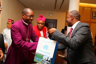 Rivers State Governor Rt. Hon. Chibuike Rotimi Amaechi presents a gift Rev James Aye Oruwori, leader of a delegation of the Niger Delta Bishops Forum