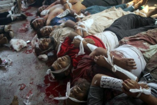 Bodies are laid out in a make shift morgue after Egyptian security forces stormed two huge protest camps at the Rabaa al-Adawiya and Al-Nahda square where supporters of ousted president Mohamed Morsi were camped,  in Cairo, on August 14, 2013. 