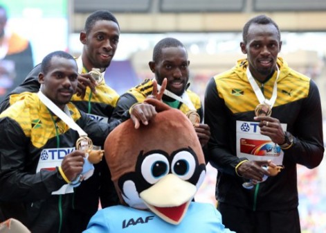 L-R) Jamaica's Nesta Carter, Kemar Bailey-Cole, Nickel Ashmeade and Usain Bolt pose with their gold medals on the podium during the medal ceremony for the men's 4x100 metres relay at the 2013 IAAF World Championships at the Luzhniki stadium in Moscow on August 18, 2013. AFP PHOTO