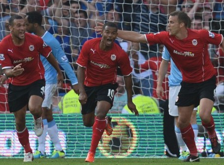 Cardiff City's striker Fraizer Campbell (2nd L) celebrates with defenders Steven Caulker (L) and Ben Turner (R) after scoring during the English Premier League football match between Cardiff City and Manchester City at The Cardiff City Stadium in Cardiff on August 25, 2013. AFP