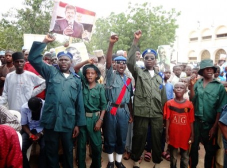 Nigerian sharia police knwon as Hisbah (in green uniforms) chant Pro-Morsi slogans during a protest on August 24,