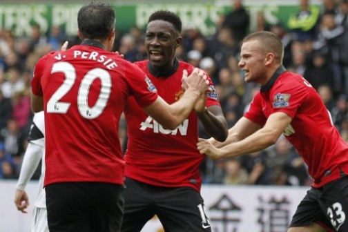 Manchester United's English striker Danny Welbeck (C) celebrates scoring his team's second goal with Manchester United's Dutch striker Robin van Persie (L) and Manchester United's English midfielder Tom Cleverley (R) during the English Premier League football match between Swansea City and Manchester United at Liberty Stadium in Swansea, south Wales, on August 17, 2013. AFP PHOTO