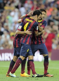 Barcelona's midfielder Cesc Fabregas (L) is congratulated by his teammate Barcelona's Brazilian forward Neymar da Silva Santos Junior (R) during the Spanish league football match FC Barcelona vs Levante UD at the Camp Nou stadium in Barcelona on August 18, 2013.  AFP PHOTO 