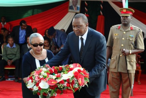 Kenyan President Uhuru Kenyatta and his wife Margaret lay a wreath at the funeral for the nephew and his fiancee