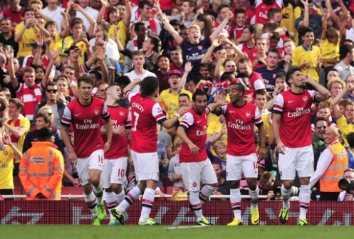 rsenal's French striker Olivier Giroud (R) celebrates with teammates after scoring the opening goal of the English Premier League football match between Arsenal and Tottenham Hotspur at the Emirates Stadium in London on September 1, 2013. AFP PHOTO