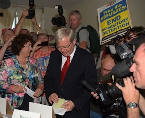 Australian Prime Minister Kevin Rudd (C) with his wife Therese Rein (L) prepares to cast his vote at St Paul's Anglican church in east Brisbane on September 7, 2013.