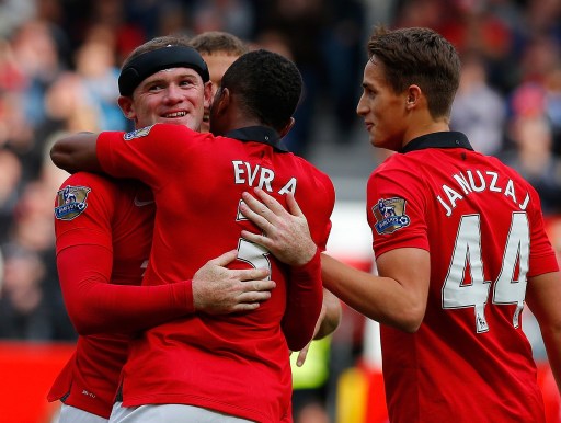 Rooney with black head band celebrate with Evra