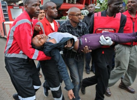 A woman who had been held hostage is carried in shock by rescue personnel on September 21, 2013, after she was freed