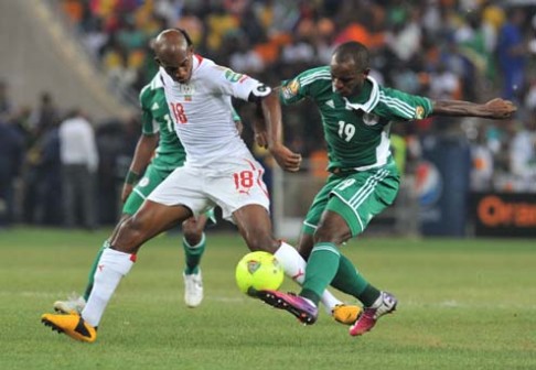 FLASHBACK...Burkina Faso's midfielder Charles Kabore (left) tackles Nigeria's forward Sunday Mba during the 2013 African Cup of Nations in February. The two teams meet again in an international friendly match in Kaduna, Nigeria today. PHOTO: AFP.
