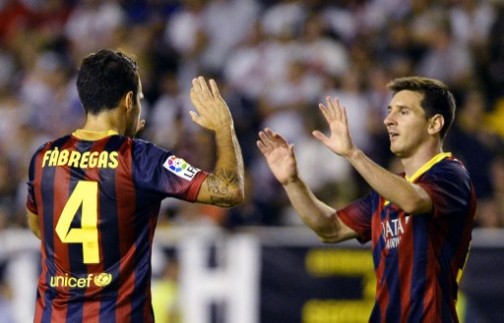 Barcelona's midfielder Cesc Fabregas (L) is congratuled by Barcelona's Argentinian forward Lionel Messi (R)  during the Spanish league football match Rayo Vallecano vs Barcelona at the Vallecas stadium in Madrid on September 21,