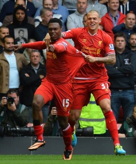 Liverpool's English striker Daniel Sturridge (L) celebrates with Liverpool's Slovakian defender Martin Skrtel after scoring the opening goal of the English Premier League football match between Liverpool and Manchester United at the Anfield stadium in Liverpool, northwest England, on September 1, 2013.