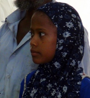 A picture taken on September 17, 2013, allegedly shows eight-year-old Rawan Mohammed Abdo Hattane (C-R) standing following a press conference in Harad in the northwestern province of Hajjah. Yemeni authorities presented to the press an eight year old girl, claiming it was Rawan, to disprove reports that she had died after being raped by her husband.