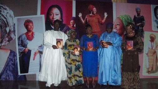 Erelu Bisi and her husband, Dr. Kayode Fayemi supported by others to display the launched books