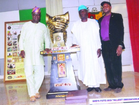 Chairman of the LOC, BRF Wrestlemania, Primate Charles Odugbesi (left) presents an Intercontinental Good Governance and Peace award to Chief of Staff to Lagos State Governor, Olarenwaju Babalola (middle), who represented Gov. Raji Fashola, while Prince Mohammed, Coordinator, BRF Wrestlemania looks on.